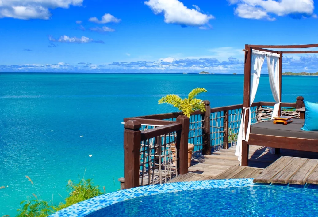 Turquoise ocean view with a luxury resort deck, pool edge, and soft destination setting.